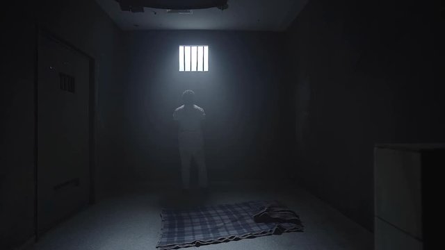 a prisoner looking in the prison room window