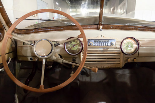 View from rear seat on the steering wheel and the interior of the old Russian retro vintage car of the executive class released in the Soviet Union beige