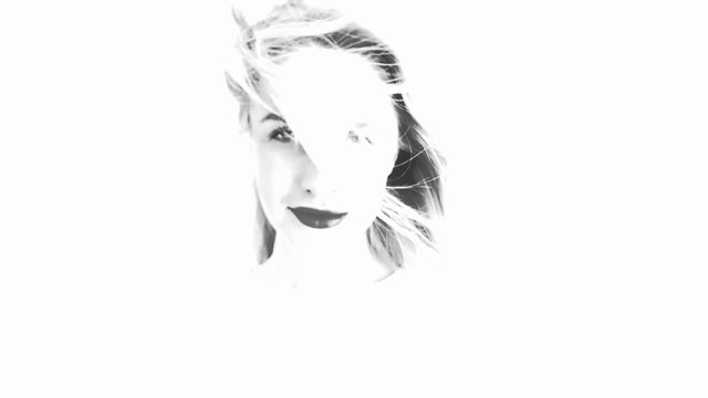 Beautiful woman with hair blowing in the wind. Change of emotions. Black and white sketch. Slow motion.