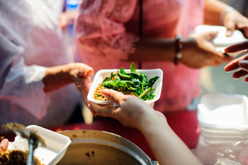The hands of beggars offer food from the donor : The life of the poor : The concept of feeding