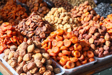  Dried apricots of different varieties in the market. in the morning sun.