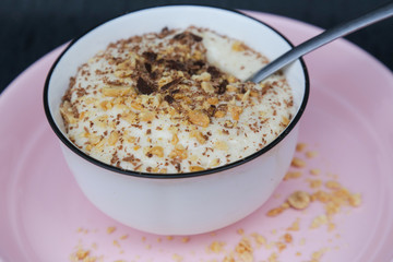 Banana smoothie bowl with peanut butter and dark chocolate pieces