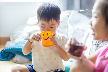 Funny child boy and girl drinking sweet ice drink