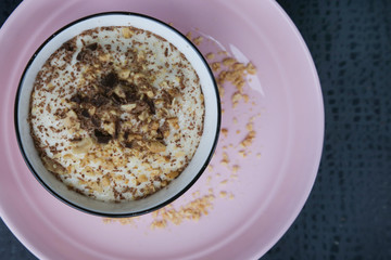 Banana smoothie bowl with peanut butter and dark chocolate pieces