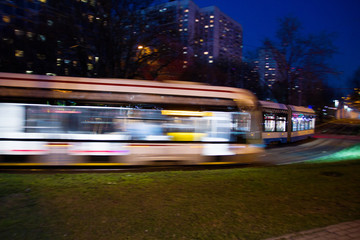 The tram is hurtling down the highway with great speed    Photo taken from the roadside ,Moscow, spring 2019, sky, tram, road 