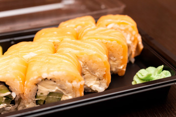 Fresh sushi and rolls fast food in a box close up