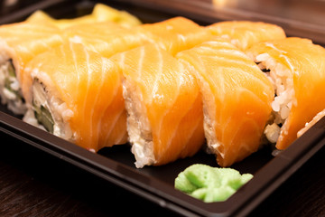 Fresh sushi and rolls fast food in a box close up