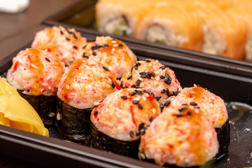 Fresh sushi and rolls fast food in a box close up