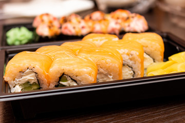 Fresh sushi and rolls fast food in a box close up