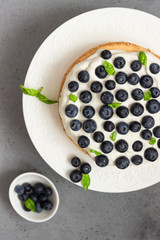 Angel food cake with whipped cream, fresh blueberries and basil. 