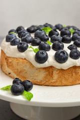 Angel food cake with whipped cream, fresh blueberries and basil. 
