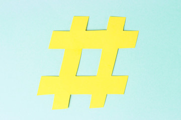 Hashtag sign isolated on blue background, close-up, network concept