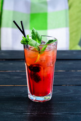 Party and holiday celebration concept. strawberry cocktail decorated with cherry in the restaurant table close up view