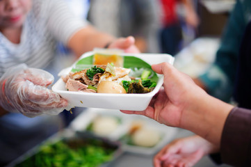 Homeless Concepts and Poverty : The hands of the poor receive food from the hands of the philanthropist : concept of giving