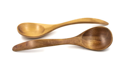 Empty wooden spoons isolated on white background, close up