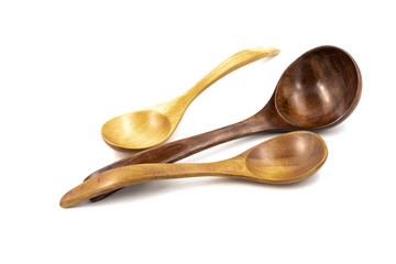 Empty wooden spoons isolated on white background, close up