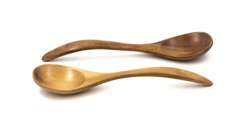 Empty wooden spoons isolated on white background, close up