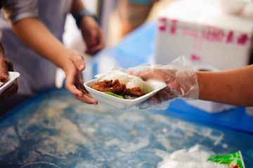 Volunteers provide food for beggars : Concepts Feeding and help : Concept of food sharing for the...