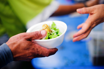 Volunteers provide food for beggars : Concepts Feeding and help : Concept of food sharing for the...