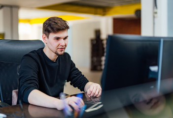 Young employee working at office desk