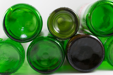 Pack of empty beer and wine green and brown glass bottom bottles, on a white background. Reuse, Eco-Friendly, Environment, Conservation, Sustainable and Resources concept.