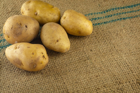 Raw potatoes for cooking on sack mats.