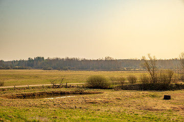 Fototapeta premium Countryside scene with fields pond and road 