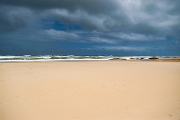 Stormy sky and clear sand on a tropical beach