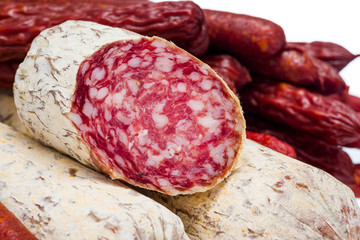 sliced natural sausage, closeup shot isolated on white background