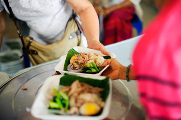 concept of begging food : Beggar begs food from donors : concept of poverty in Asian society