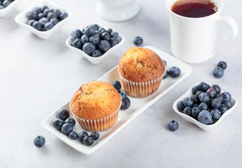 Muffins and blueberry on white table.