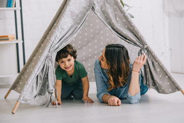Mom and smiling little son in grey wigwam at home © LIGHTFIELD STUDIOS