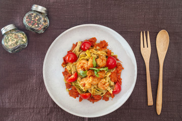 Cooked pasta with peeled shrimp, coconut milk sauce and broccoli
