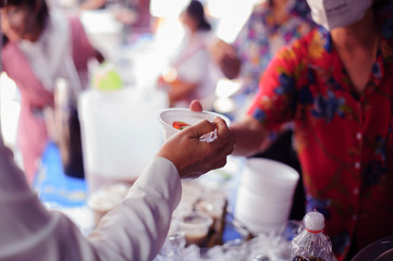 Beggar begs food from donors: Caring for fellow human beings in society by giving food, Giving...