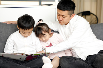 Obraz premium Parents Child Family father mother daughter son sit on sofa reading writing study teaching