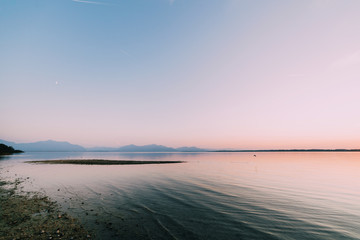 Amazing sunset in chiemsee lake with mountains in background