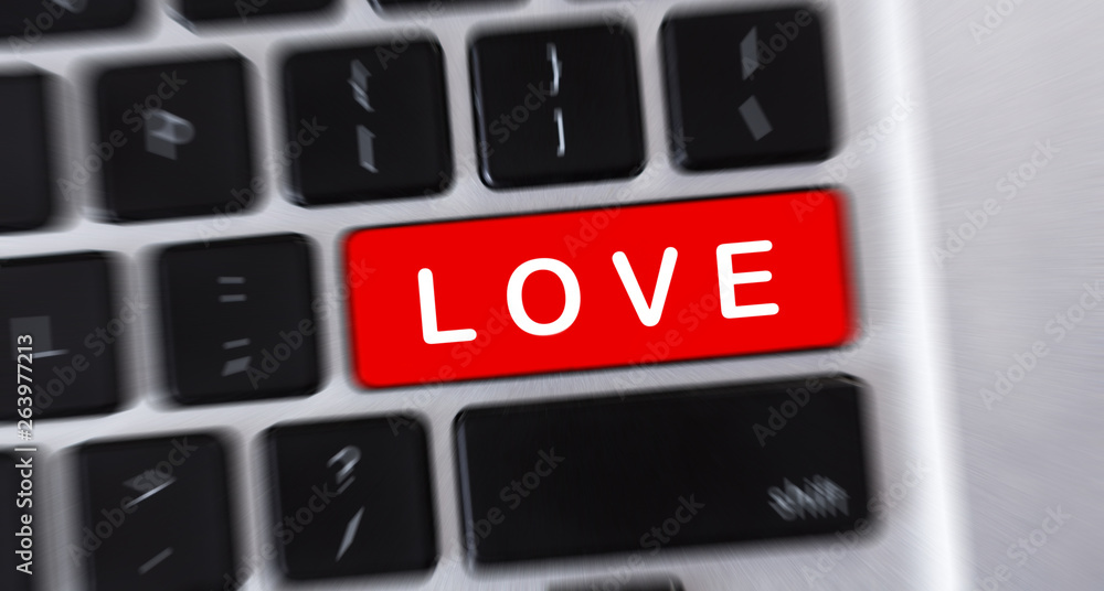 Aufkleber LOVE text on red button of computer keyboard