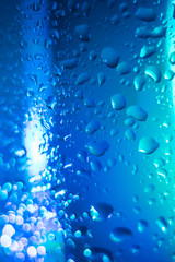 Naklejka na ściany i meble blue with a turquoise drop on a glass surface, macro, abstraction