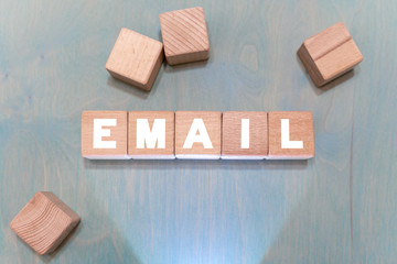 Email management office work concept on a wooden blocks background. Mail marketing.
