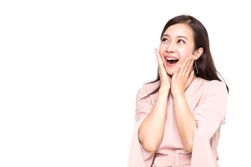 Portrait of excited screaming young asian woman standing in pink dress isolated over white...