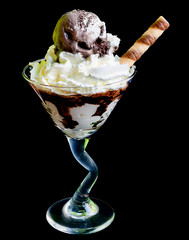 Ice cream in a cocktail glass isolated on a black background