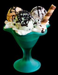 Ice cream in a green glass isolated on a black background