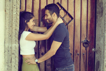 Couple in love outside a rustic house.