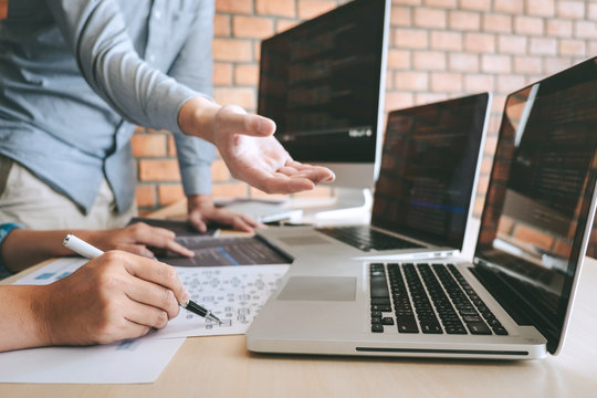 Team of Professional Developer programmer cooperation meeting and brainstorming and programming in website working a software and coding technology, writing codes and database