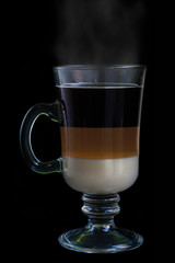 Special coffee in a nice glass cup isolated on black background