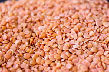 Red lentils in a box on a black background