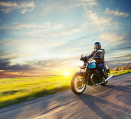 Fototapeta na wymiar Motorcycle driver riding in European road