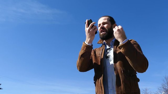 The man actively swears with the interlocutor on the phone