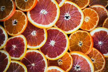 Sliced Blood Oranges and Tangerines on Dark Background