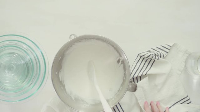 Step by step. Flat lay. Mixing royal icing to decorate Easter sugar cookies.